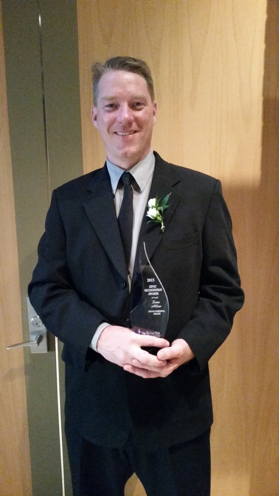 Sean Allen holding his 2015 Civic Recognition Award